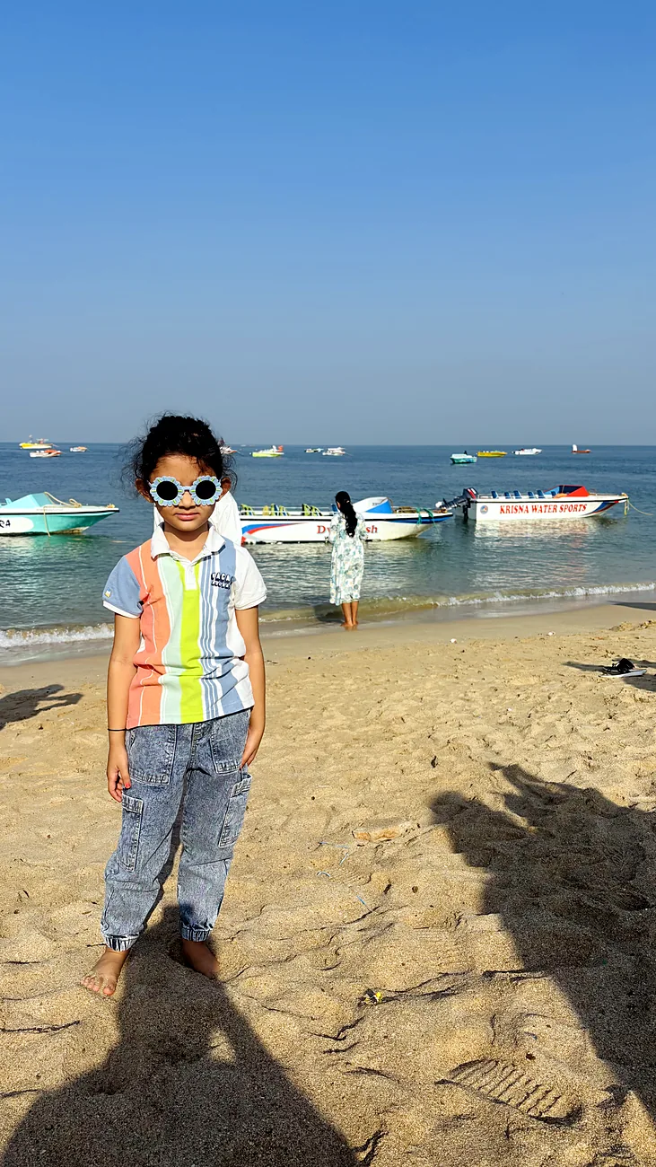 Nityaah on the beach in sunglasses