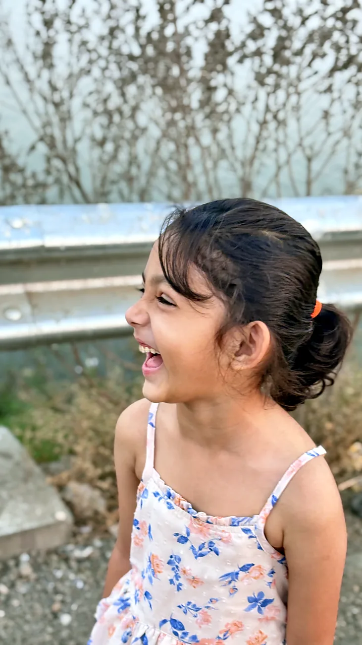 Nityaah laughing by the roadside