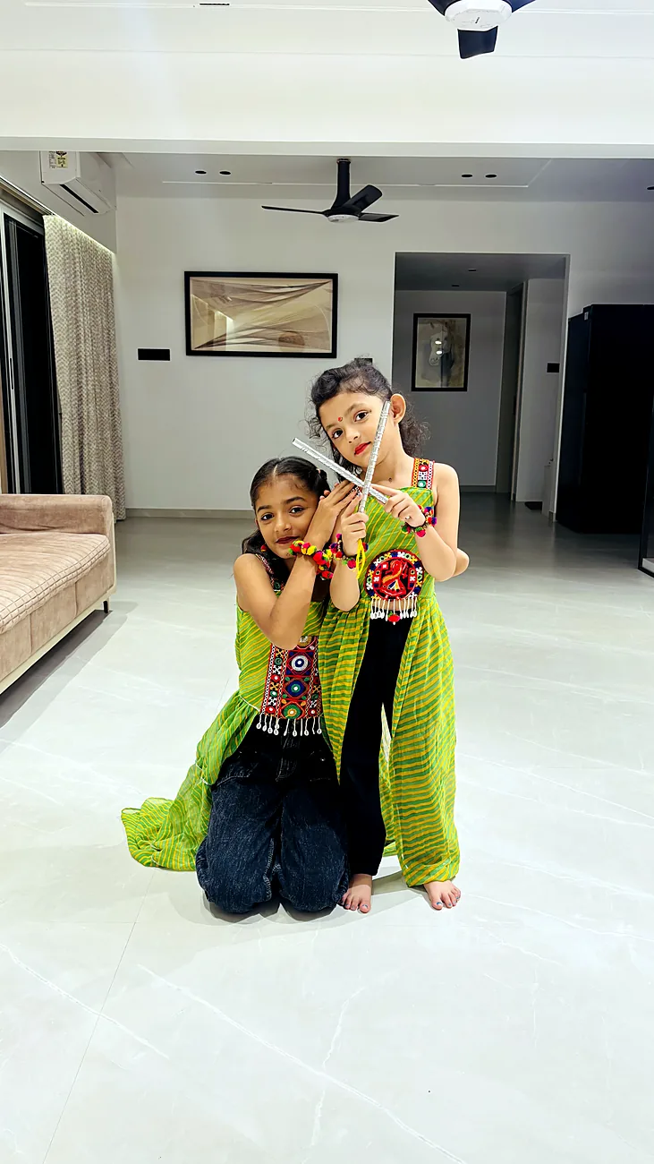 The sisters in green and black outfits at home